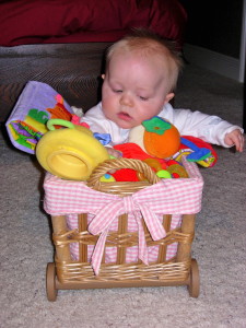 Max Bailey sitting supported in a basket. 